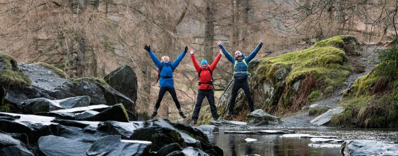 happy hikers with arms outstretched