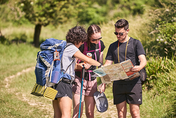 A group of walkers examine a paper map