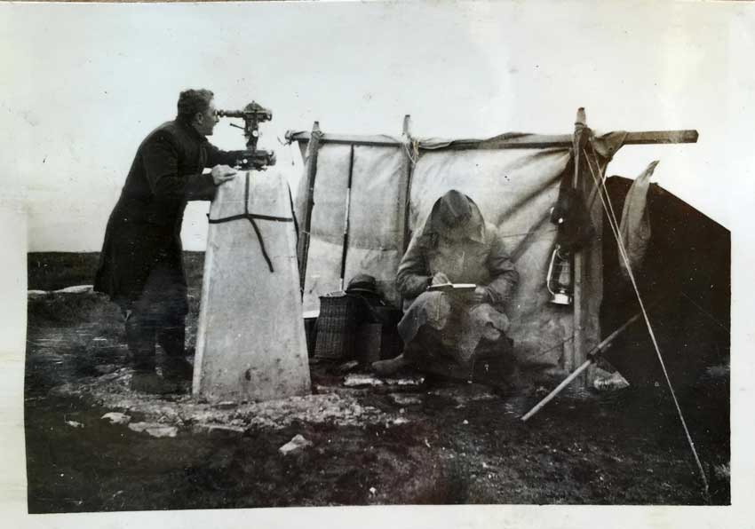Surveyors camping next to a trig pillar