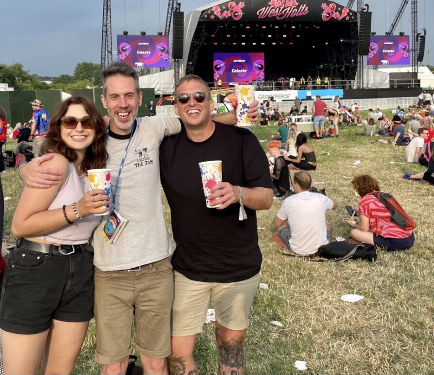a happy group of friends at glastonbury festival
