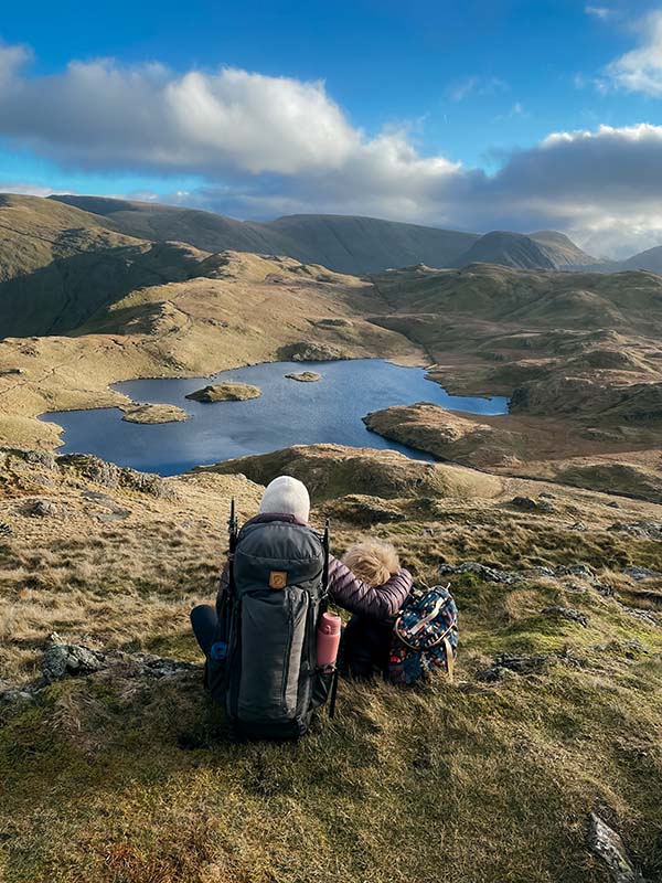 at the summit looking out to the view of the lake district with @thelittlesandthelakes