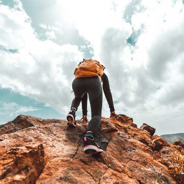 A person climbing a steep rock