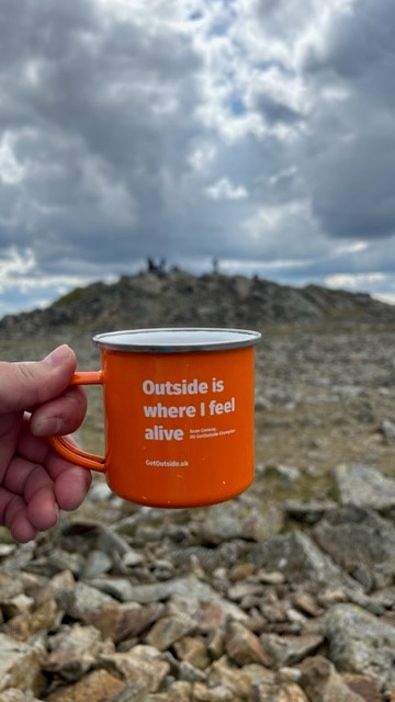 metal ordnance survey mug on top of Moel Siabod