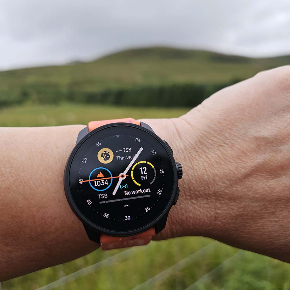 Suunto Race S Watch on wrist in mountains