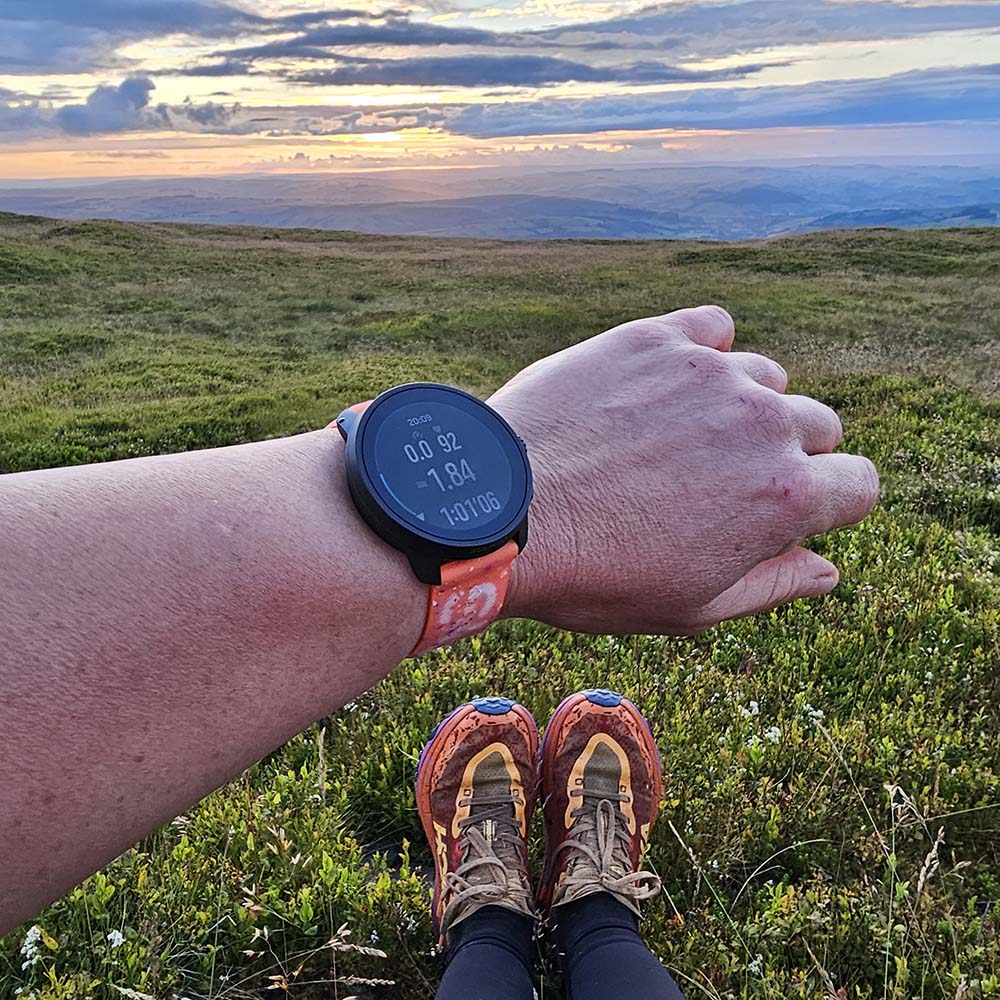 Suunto Race S Watch on wrist in mountains