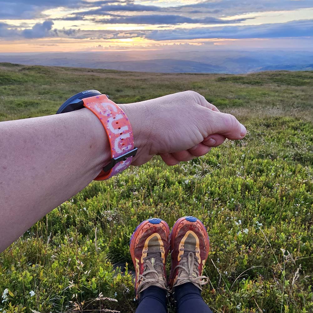 Suunto Race S Watch on wrist in mountains