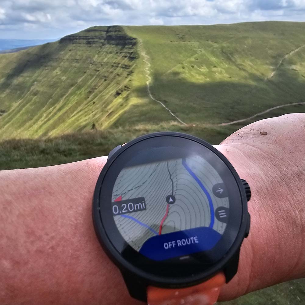 Suunto Race S Watch on wrist in mountains