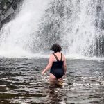 wild swimming by a waterfall