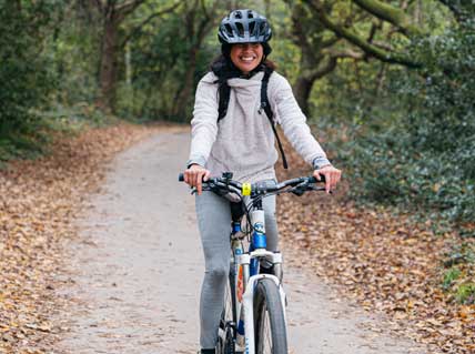 person riding a bike on a forest trail