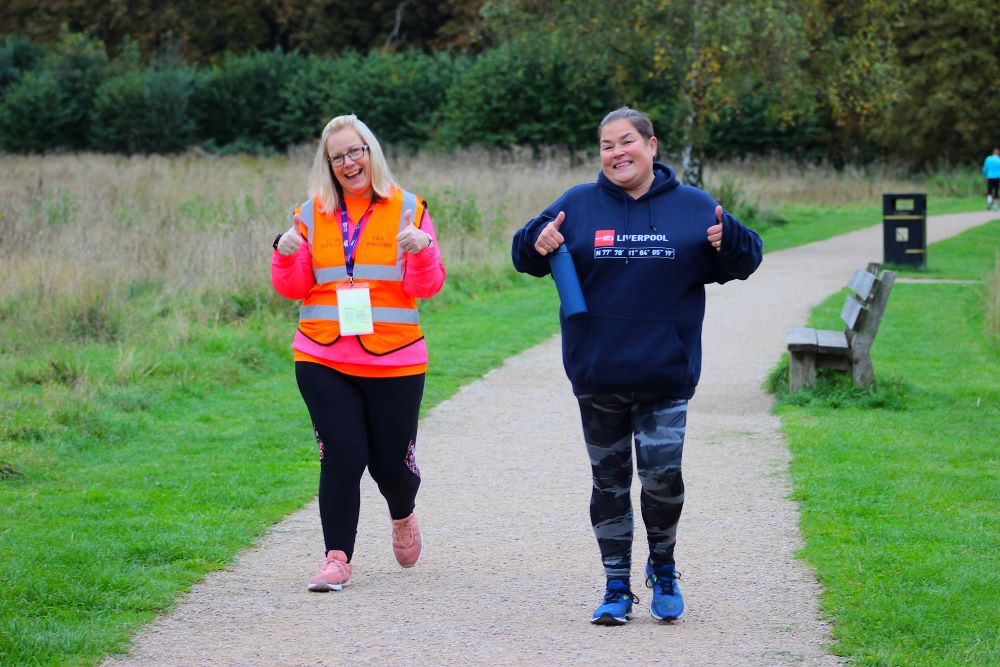 runner and volunteer on a park run