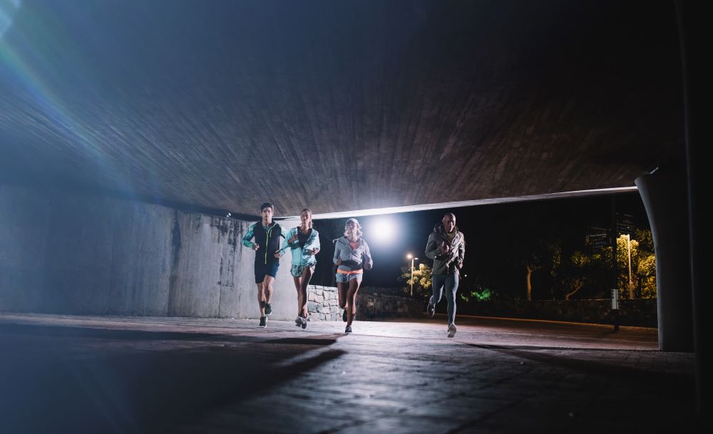 running under an underpass in the dark with friends