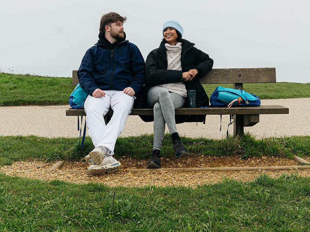 A couple sat outside on a bench