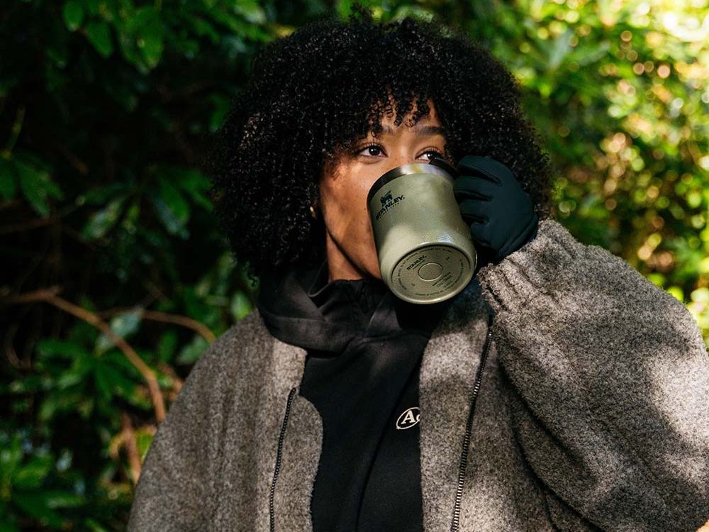 A lady drinking coffee in winter outdoors
