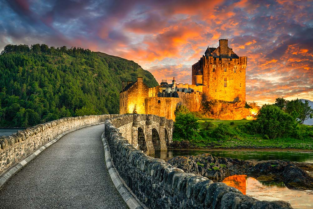 Eilean Donan Castle at sunset in Scotland.