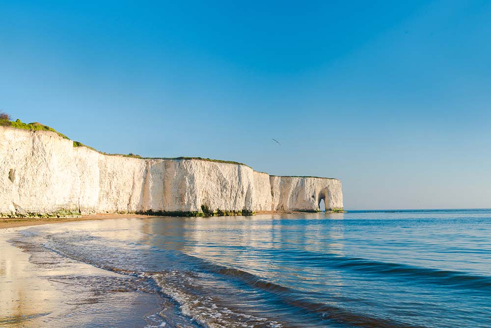 View of white chalk cliffs and beach in Kingsgate Bay, Margate,