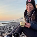 May Cheung drinking coffee on Birling Gap Walk