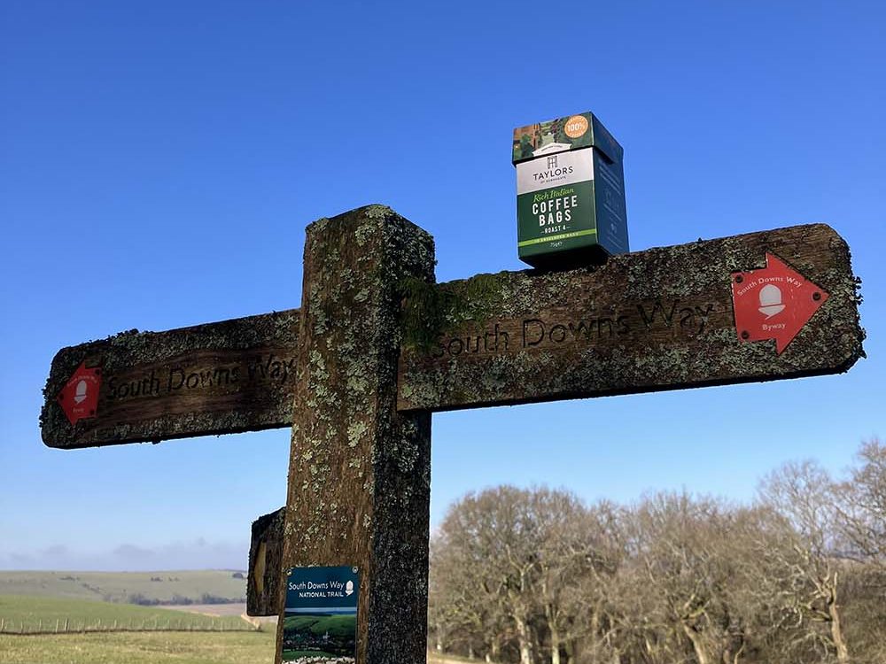 finger post with pack of coffee on south downs way