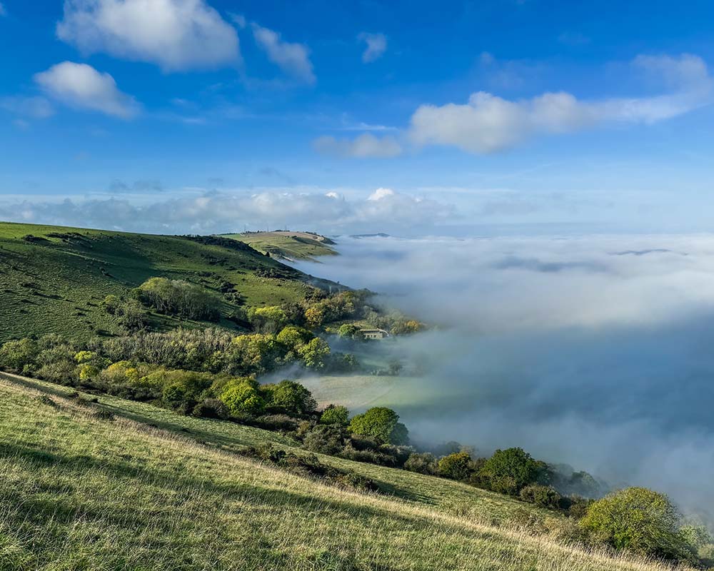 green hills and woodland with fog Devils Dyke Walk