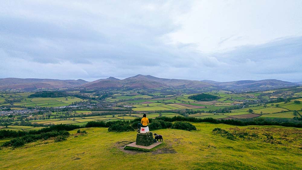 sitting on the trig at pen y crug hillfort