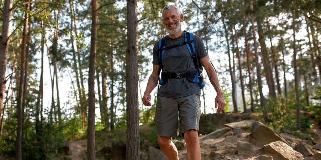 Man in shorts walking in the woods
