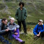 Group of walkers checking the map