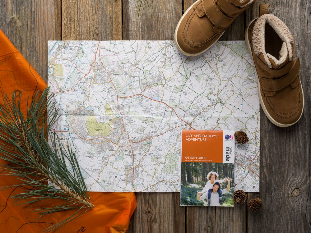 personalised mini map flat lay shot with a pair of childs shoes
