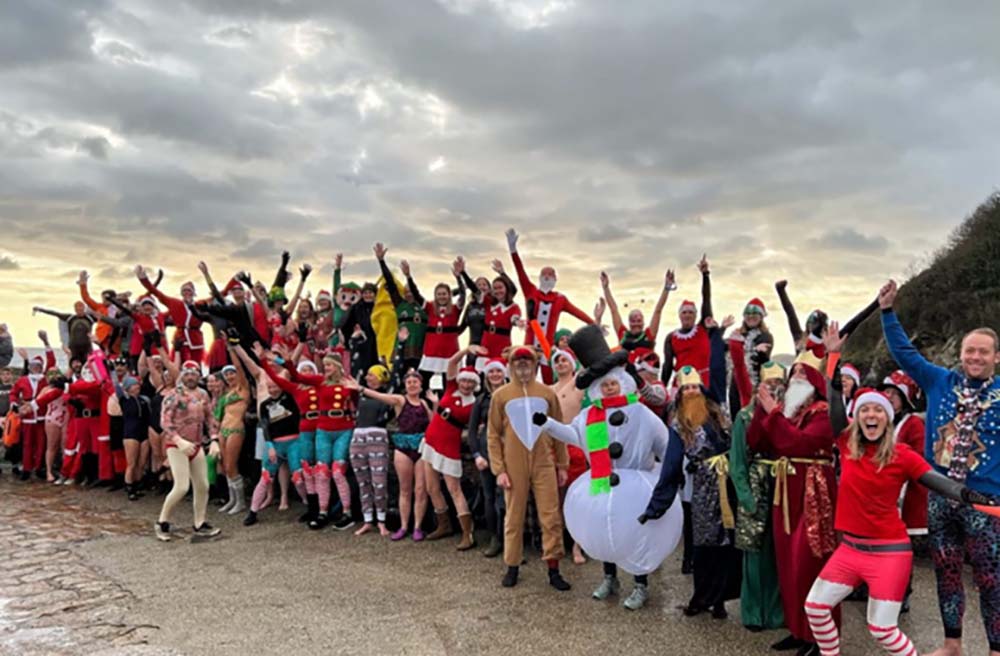 mass sea dipping lots of people ready to run into the sea, some are in fancy dress