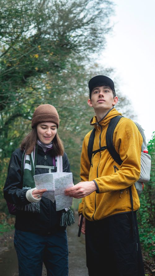 Couple outdoors looking at a map