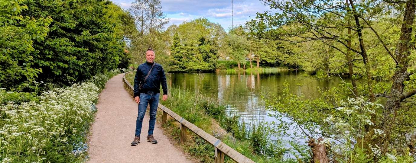 Dr Andrew Read by a canal in spring in manchester