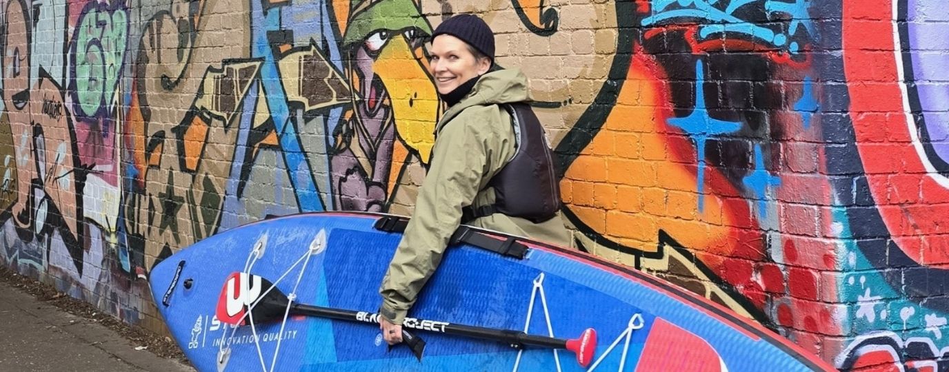Paddleboarding in London - Anu Aladin with Graffiti behind