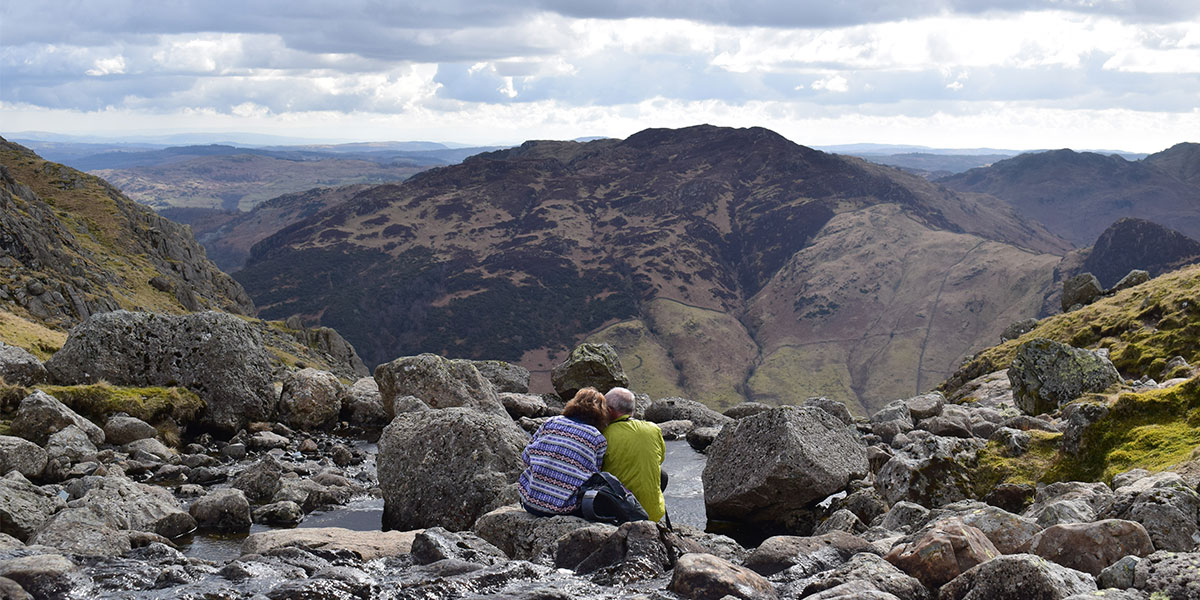 Two hikers enjoy a break at Stickle Tarn