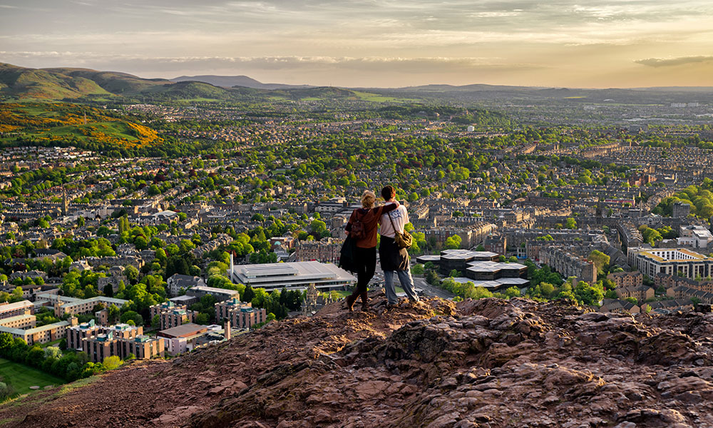 Couple overlooking Edinburgh on Arthur's Seat