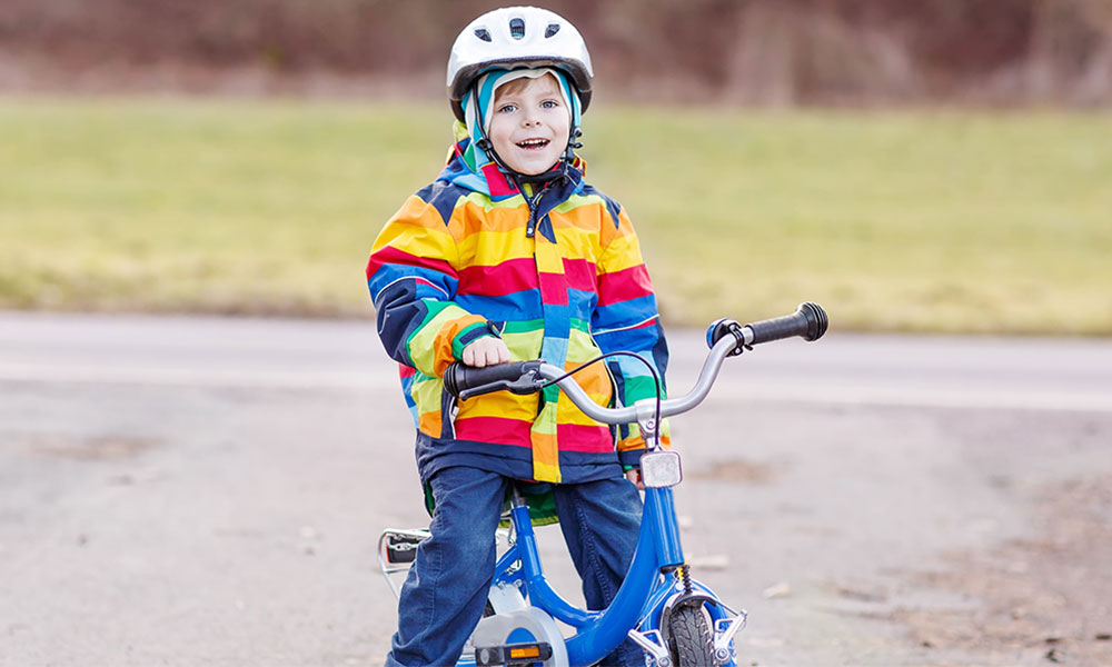 Child on bike in winter coat