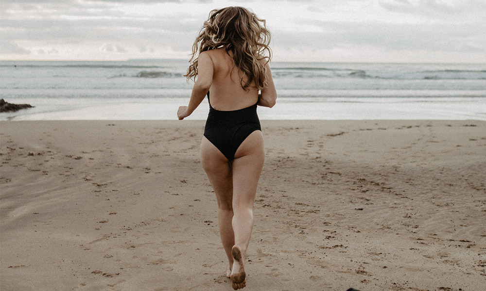 woman running into a cold sea 