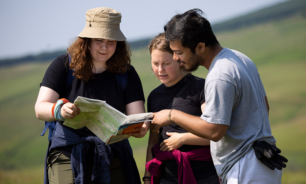 young people hiking with an OS Map