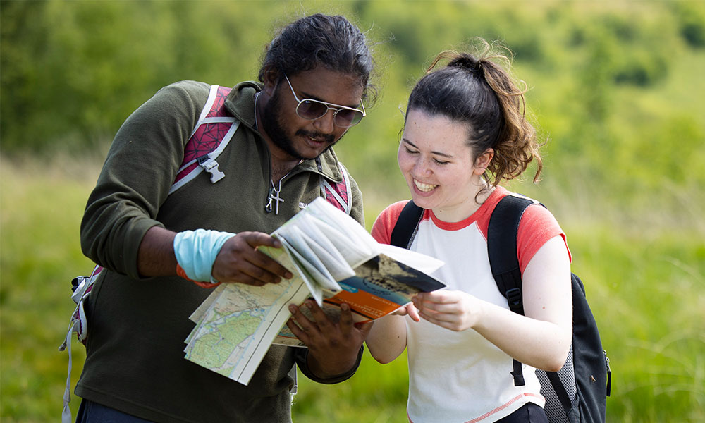 two young people reading an OS Map