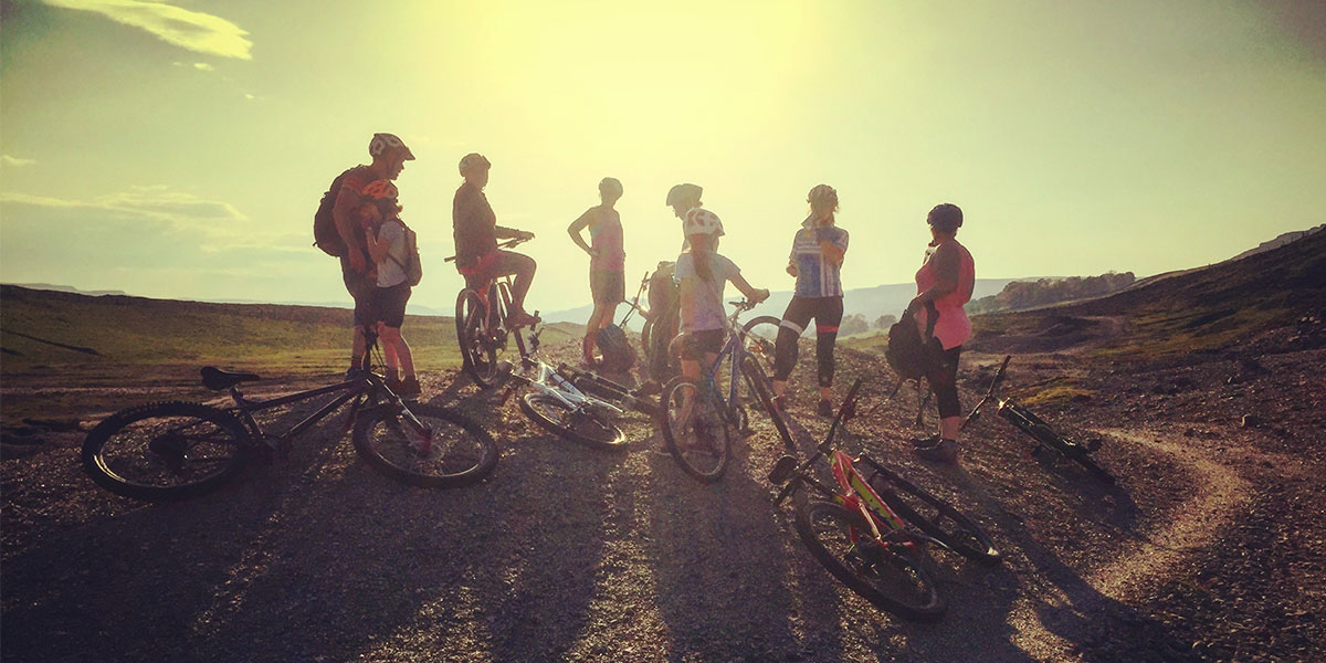 Group cycling at sunset