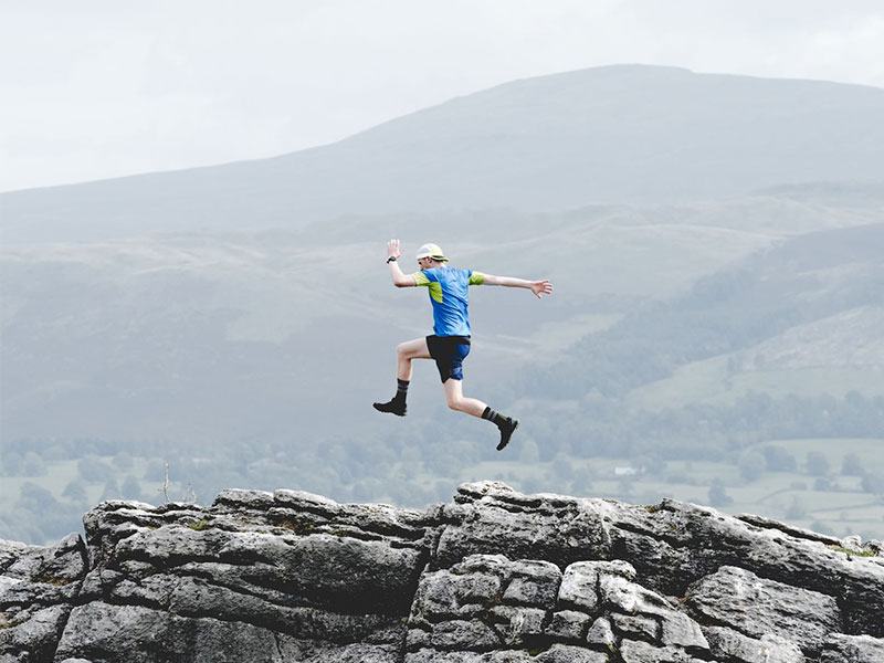 Rory jumping atop limestone crag