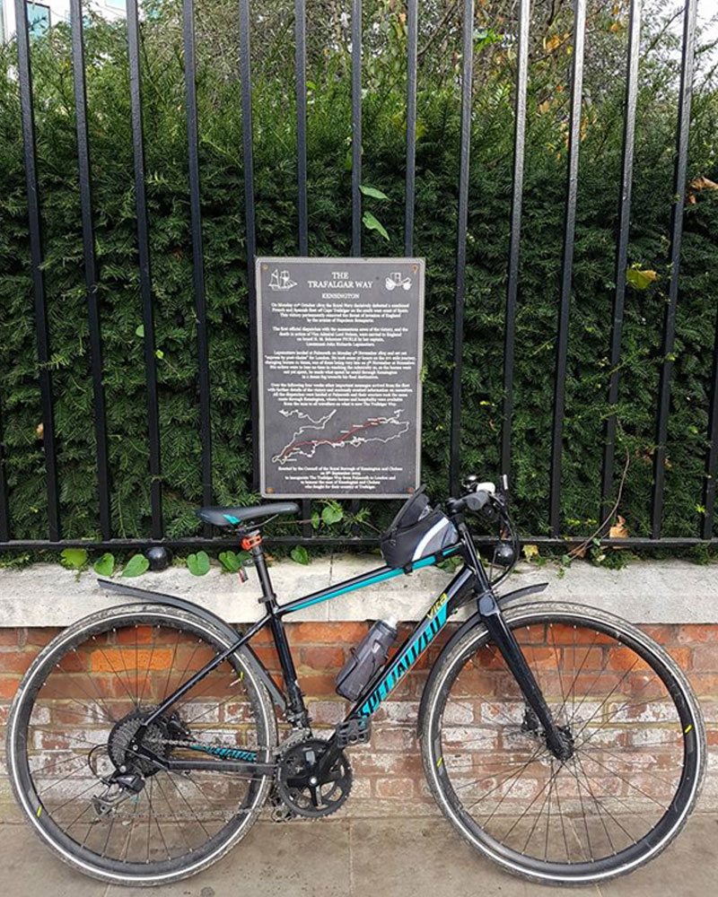 Bike against railings and Trafalgar Way sign